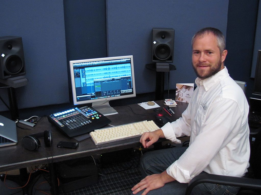 Benjamin Good at his audio desk in the recording studio